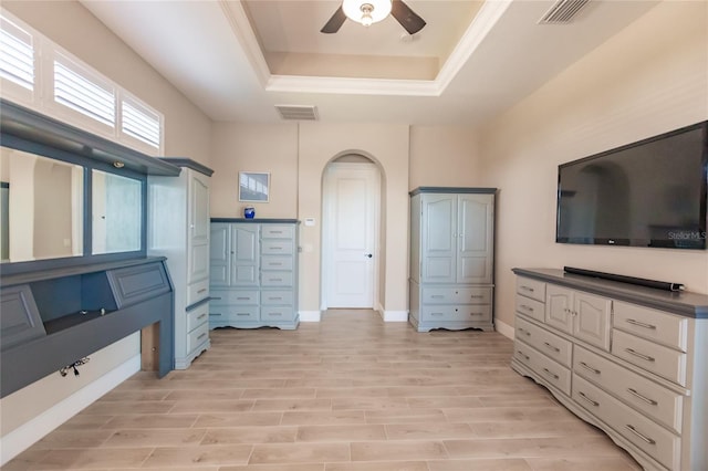 interior space featuring a tray ceiling, ceiling fan, and light hardwood / wood-style flooring