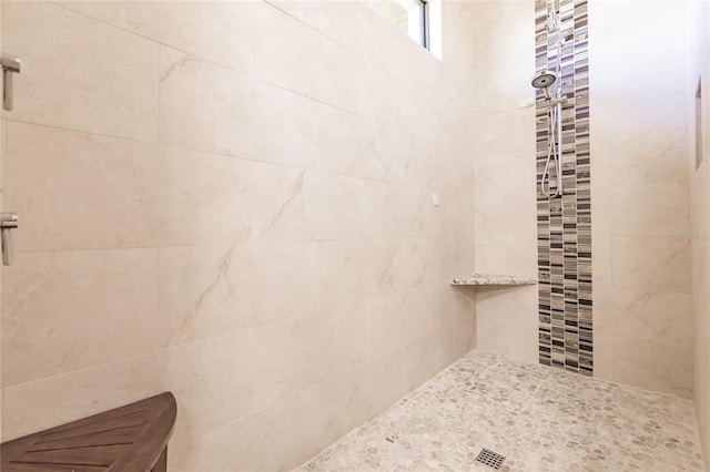 bathroom with a tile shower