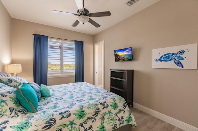 bedroom with ceiling fan and hardwood / wood-style floors