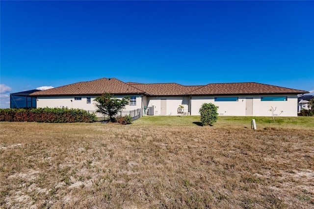 rear view of property featuring a lawn