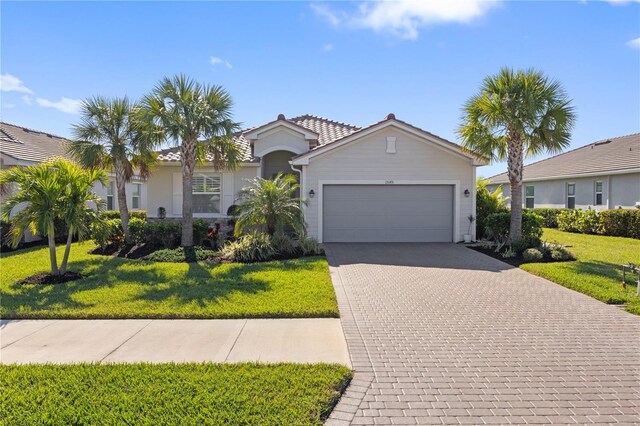 view of front facade with a front yard and a garage