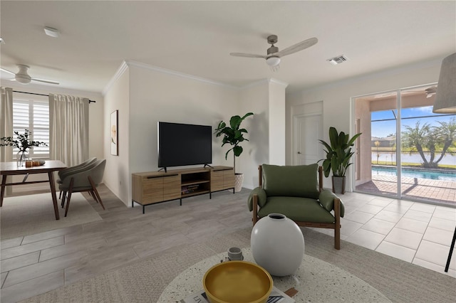 living room with ceiling fan, light tile patterned floors, and crown molding