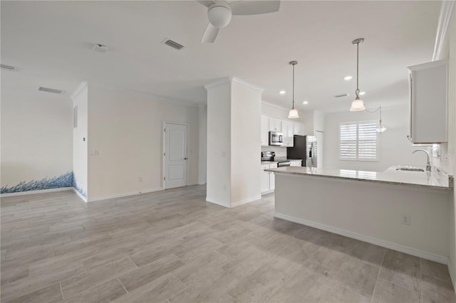 kitchen with light stone countertops, white cabinetry, sink, ceiling fan, and stainless steel appliances