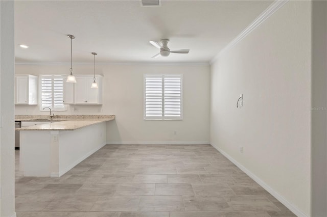 kitchen featuring kitchen peninsula, ceiling fan, sink, decorative light fixtures, and white cabinetry