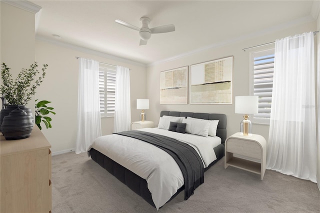 carpeted bedroom featuring multiple windows, ceiling fan, and crown molding