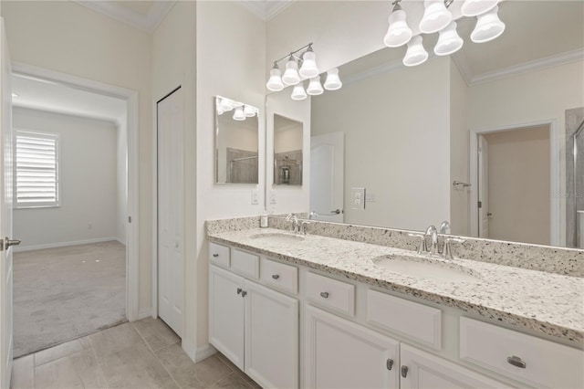 bathroom featuring a notable chandelier, vanity, crown molding, and tile patterned floors