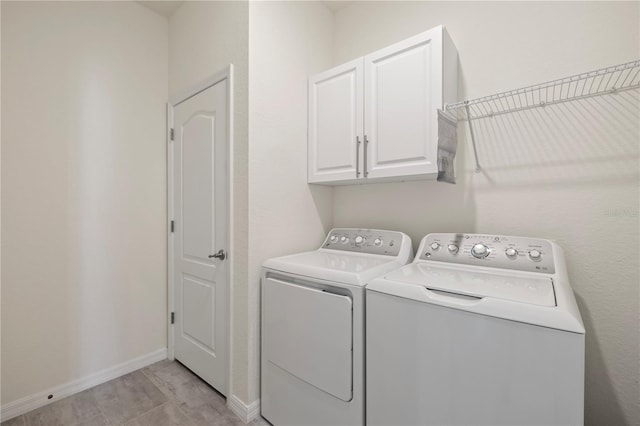 laundry room featuring cabinets and washing machine and dryer