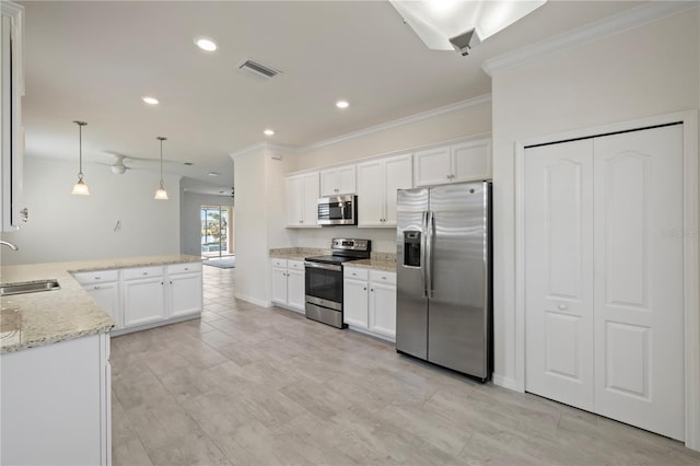 kitchen with pendant lighting, white cabinetry, sink, and appliances with stainless steel finishes