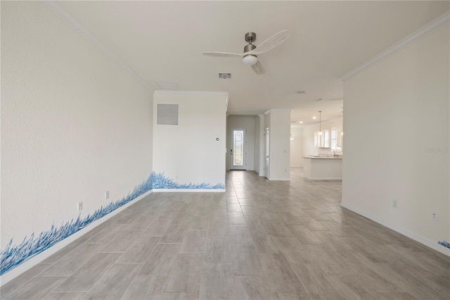 empty room with ceiling fan and ornamental molding