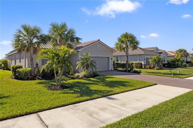 single story home featuring a garage and a front lawn