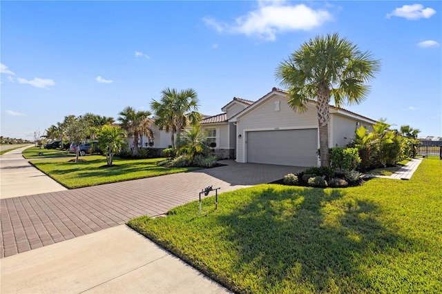 view of front of property with a garage and a front yard