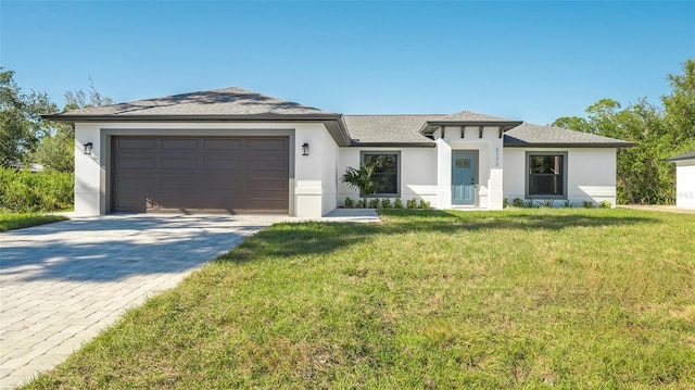 view of front of property with a garage and a front lawn