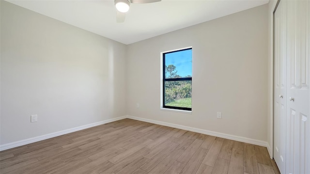 spare room with light wood-type flooring and ceiling fan