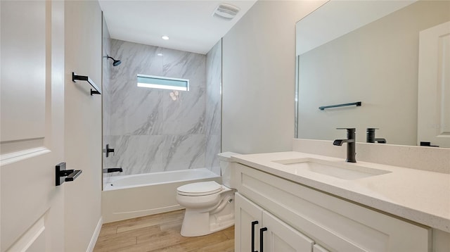 full bathroom with vanity, tiled shower / bath combo, and toilet