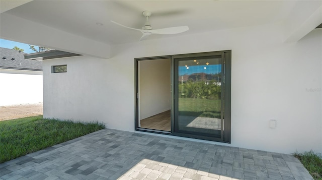 doorway to property featuring ceiling fan and a patio area