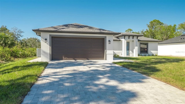 view of front of property featuring a garage and a front lawn