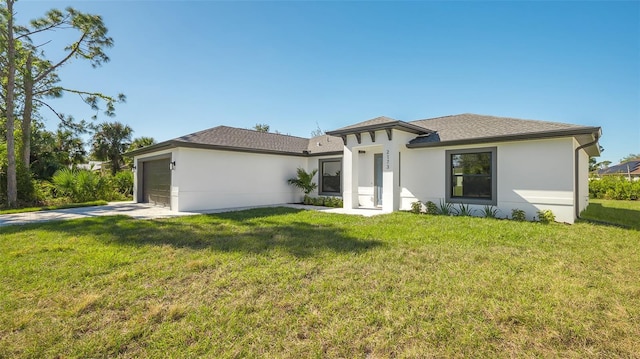 view of front facade with a garage and a front lawn