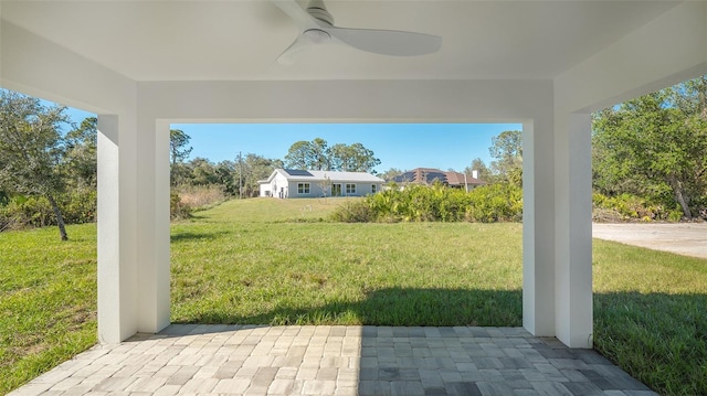 view of yard featuring a patio and ceiling fan