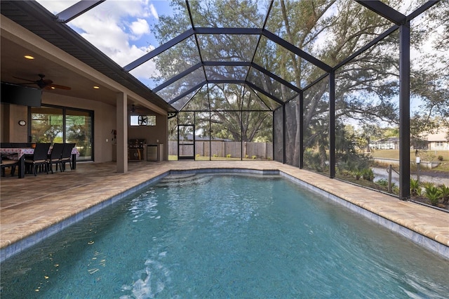 view of pool with a lanai, a patio area, ceiling fan, and area for grilling