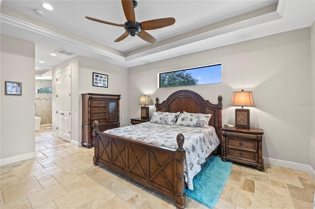 bedroom featuring ceiling fan, a raised ceiling, and connected bathroom