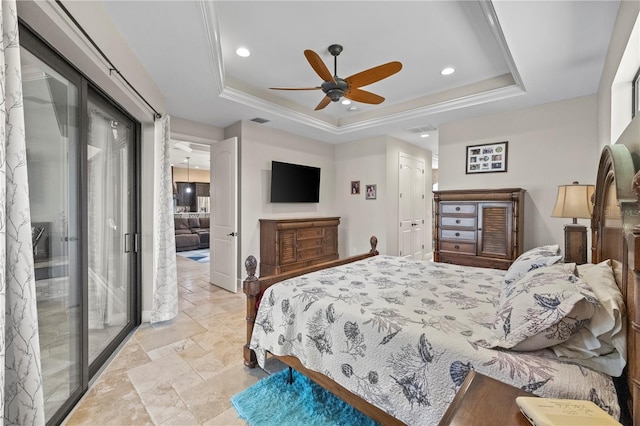 bedroom with a tray ceiling, ceiling fan, and crown molding