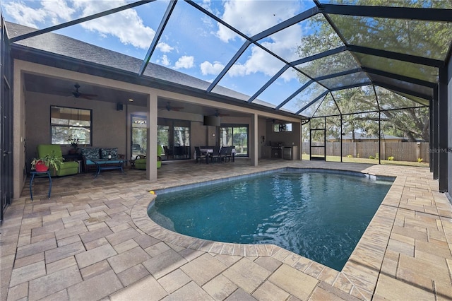 view of swimming pool featuring a lanai, an outdoor living space, ceiling fan, and a patio area