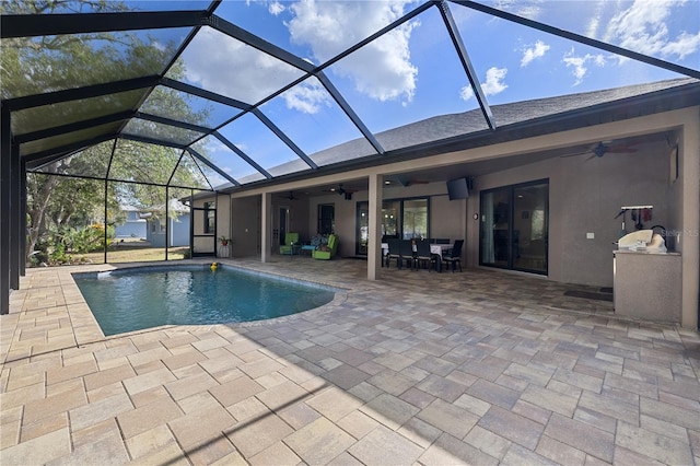 view of pool featuring ceiling fan, a patio area, and glass enclosure