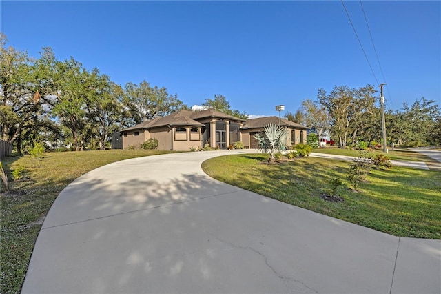 view of front of property with a garage and a front yard