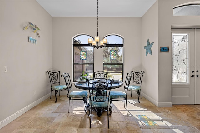 dining area with plenty of natural light and an inviting chandelier