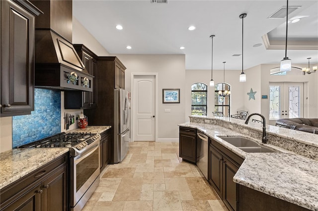 kitchen with french doors, stainless steel appliances, tasteful backsplash, pendant lighting, and dark brown cabinets