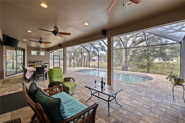 exterior space with a lanai, an outdoor living space, ceiling fan, and a patio