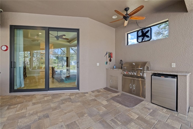 view of patio / terrace featuring sink, an outdoor kitchen, ceiling fan, and grilling area