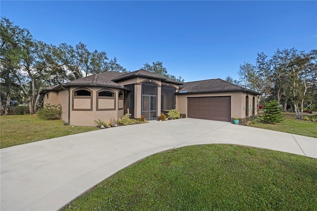 view of front of property with a front yard and a garage