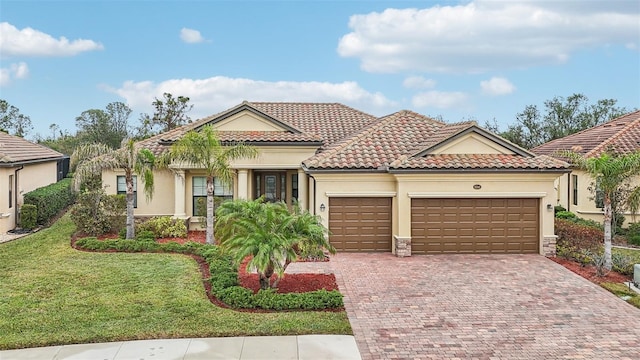 mediterranean / spanish home with a front lawn and a garage