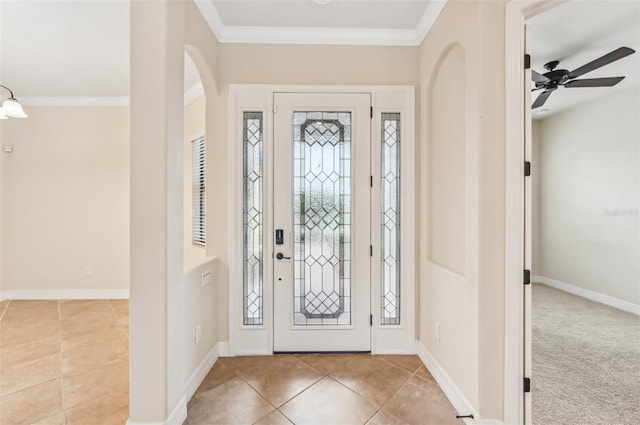 foyer with ceiling fan, light colored carpet, and ornamental molding