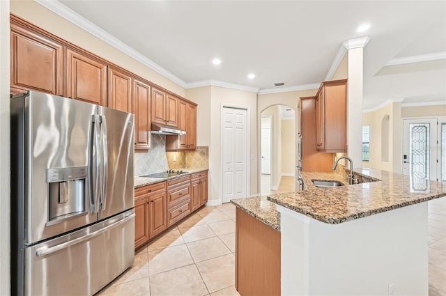 kitchen with sink, stainless steel refrigerator with ice dispenser, light tile patterned floors, light stone counters, and kitchen peninsula