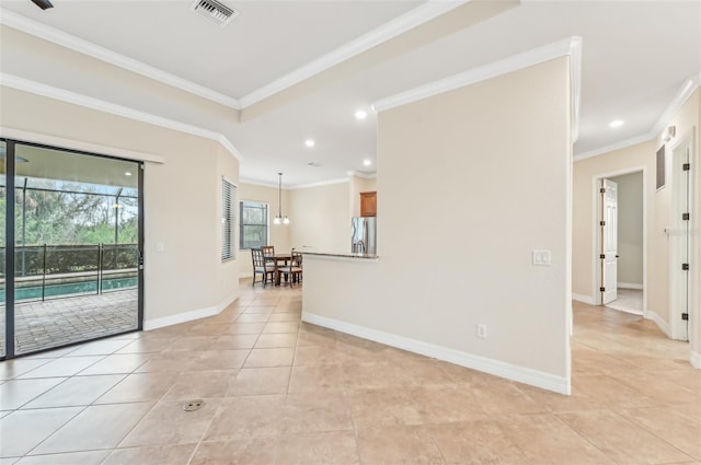 empty room featuring crown molding and light tile patterned flooring