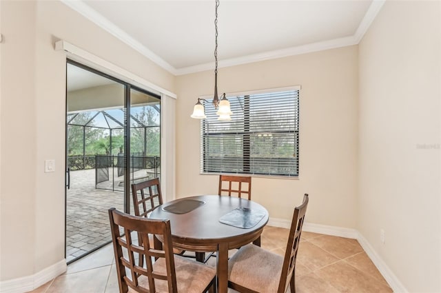 dining area with a notable chandelier, light tile patterned flooring, and ornamental molding