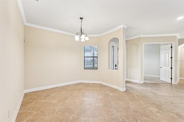 spare room with ornamental molding and an inviting chandelier