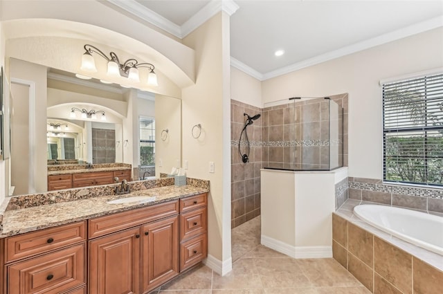 bathroom featuring plus walk in shower, vanity, crown molding, and tile patterned flooring