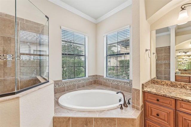 bathroom featuring a wealth of natural light, vanity, and ornamental molding