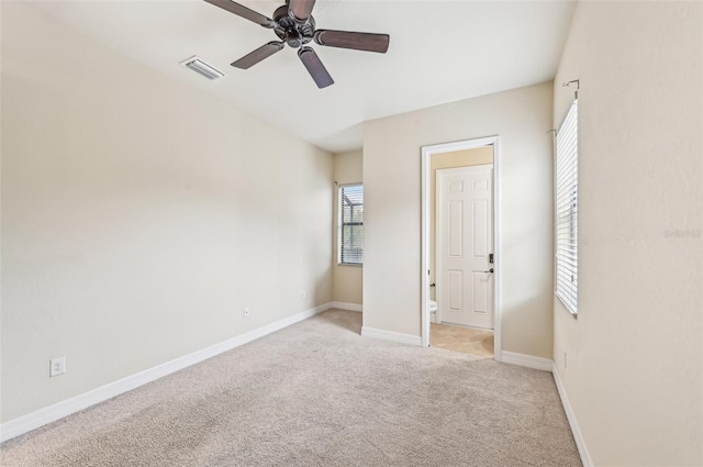 unfurnished bedroom featuring ceiling fan and light colored carpet