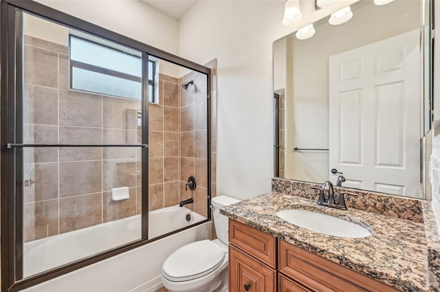 full bathroom with toilet, vanity, and combined bath / shower with glass door