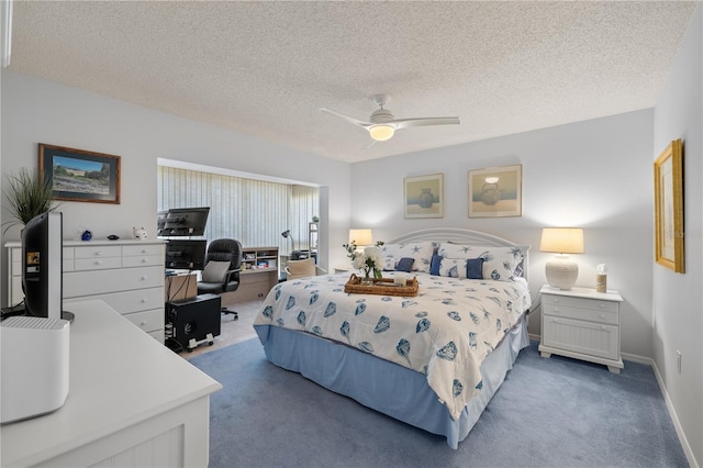 carpeted bedroom featuring ceiling fan and a textured ceiling