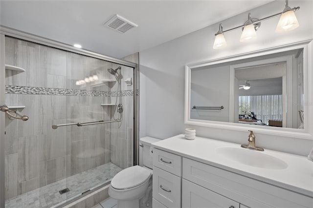 bathroom with ceiling fan, toilet, vanity, and walk in shower