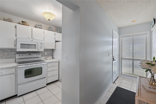 kitchen with white cabinetry, backsplash, a textured ceiling, white appliances, and light tile patterned floors