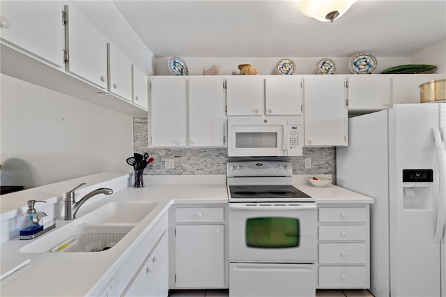 kitchen with decorative backsplash, white appliances, white cabinetry, and sink