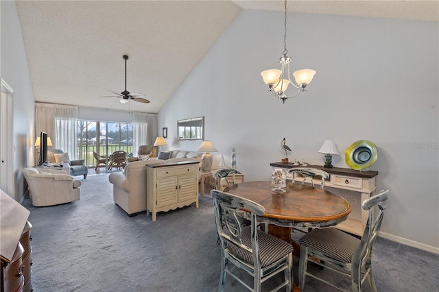 carpeted dining area with ceiling fan with notable chandelier and high vaulted ceiling