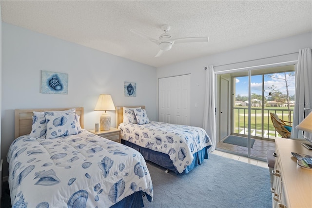 carpeted bedroom with access to outside, ceiling fan, a closet, and a textured ceiling