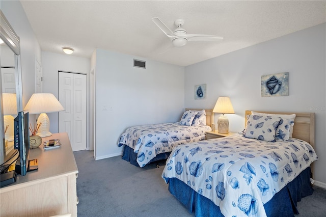 carpeted bedroom with ceiling fan, a textured ceiling, and a closet